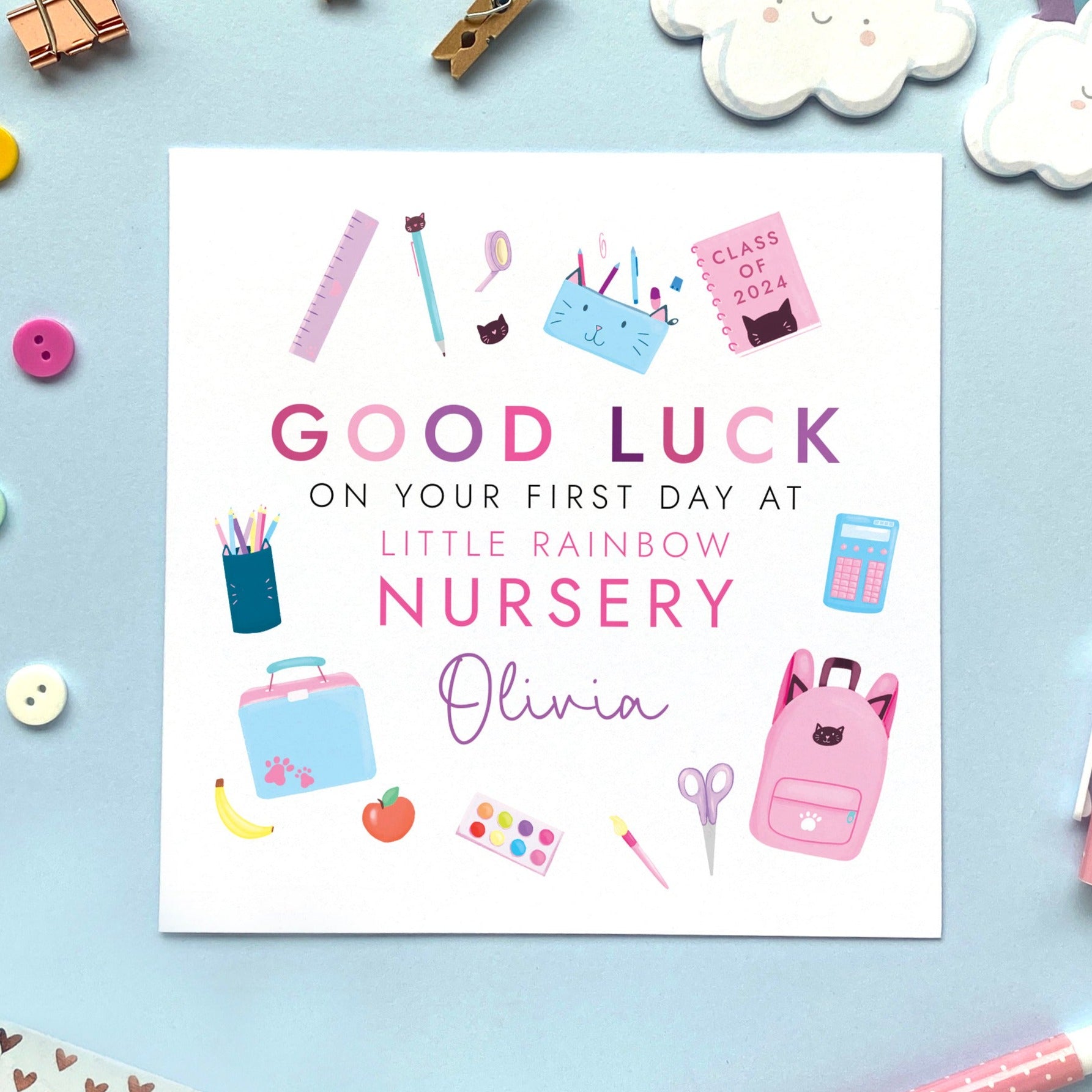 A personalised first day at nursery card for girl, featuring different school related objects in a pink theme. It can be personalised with the school and the child's name. It's suitable for primary school, secondary school, infant school and nursery, for relations such as daughter, granddaughter, niece, cousin, sister and little girl.