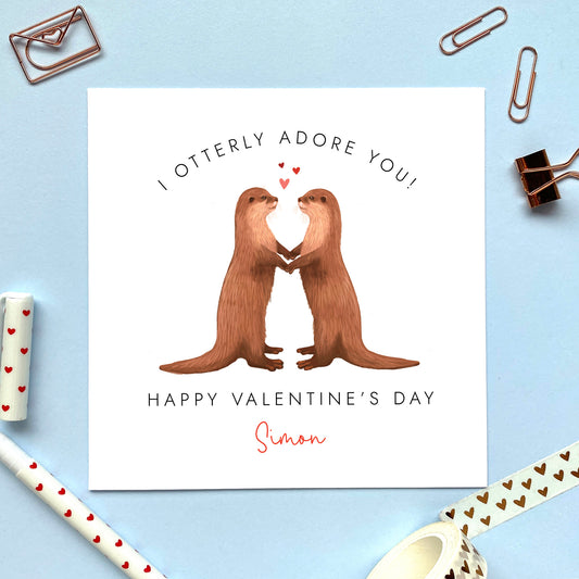 A personalised valentine's day card featuring two otters and the pun 'I otterly adore you'.