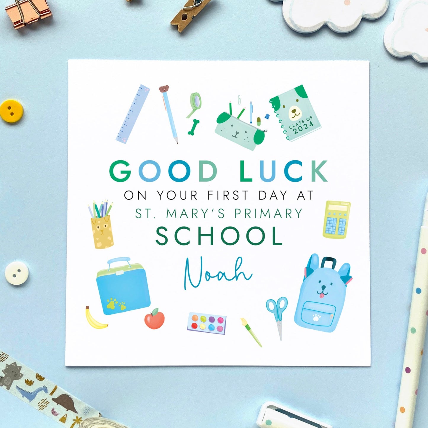 A personalised first day at school card for boy, featuring a variety of school themed objects in blue and green. It can be personalised with a child's name and school. It is also suitable for 1st day at primary school, secondary school, nursery and infant school. It is ideal for relations such as son, grandson, little boy, nephew, godson, brother and cousin.