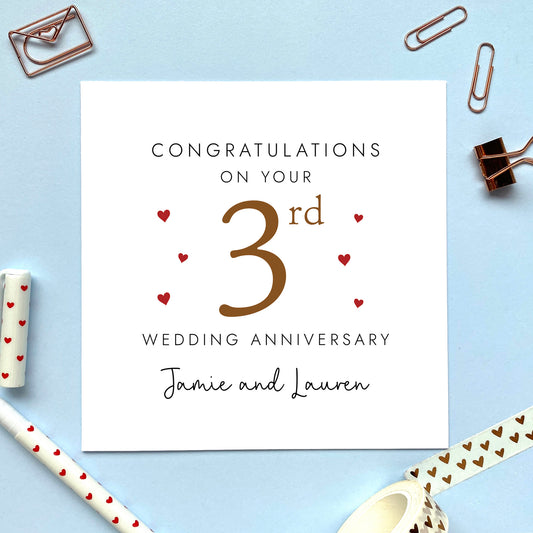 A personalised 3rd wedding anniversary card for couple. It features '3rd' in brown with red hearts, the colour scheme matches the theme of leather. The text reads 'Congratulations on your 3rd wedding anniversary'. This card can be personalised with two names, and is suitable for special friends and family relations such as Daughter and Son-in-Law and Son and Daughter-in-Law. It is also suitable for gay and lesbian couples.