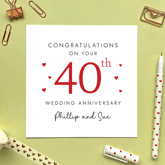 A personalised 40th wedding anniversary card for couple. It features '40th' in red with hearts, the colour scheme matches the theme of ruby. The text reads 'Congratulations on your 40th wedding anniversary'. This card can be personalised with two names, and is suitable for special friends and family relations such as parents, grandparents, Mum and Dad, Brother and Sister in Law, Daughter and Son-in-Law and Son and Daughter-in-Law. It is also suitable for gay and lesbian couples.