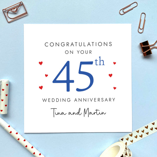 A personalised 45th wedding anniversary card for couple. It features '45th' in blue with red hearts, the colour scheme matches the theme of sapphire. The text reads 'Congratulations on your 50th wedding anniversary'. This card can be personalised with two names, and is suitable for special friends and family relations such as parents, grandparents, Mum and Dad, Brother and Sister in Law, Daughter and Son-in-Law and Son and Daughter-in-Law. It is also suitable for gay and lesbian couples.