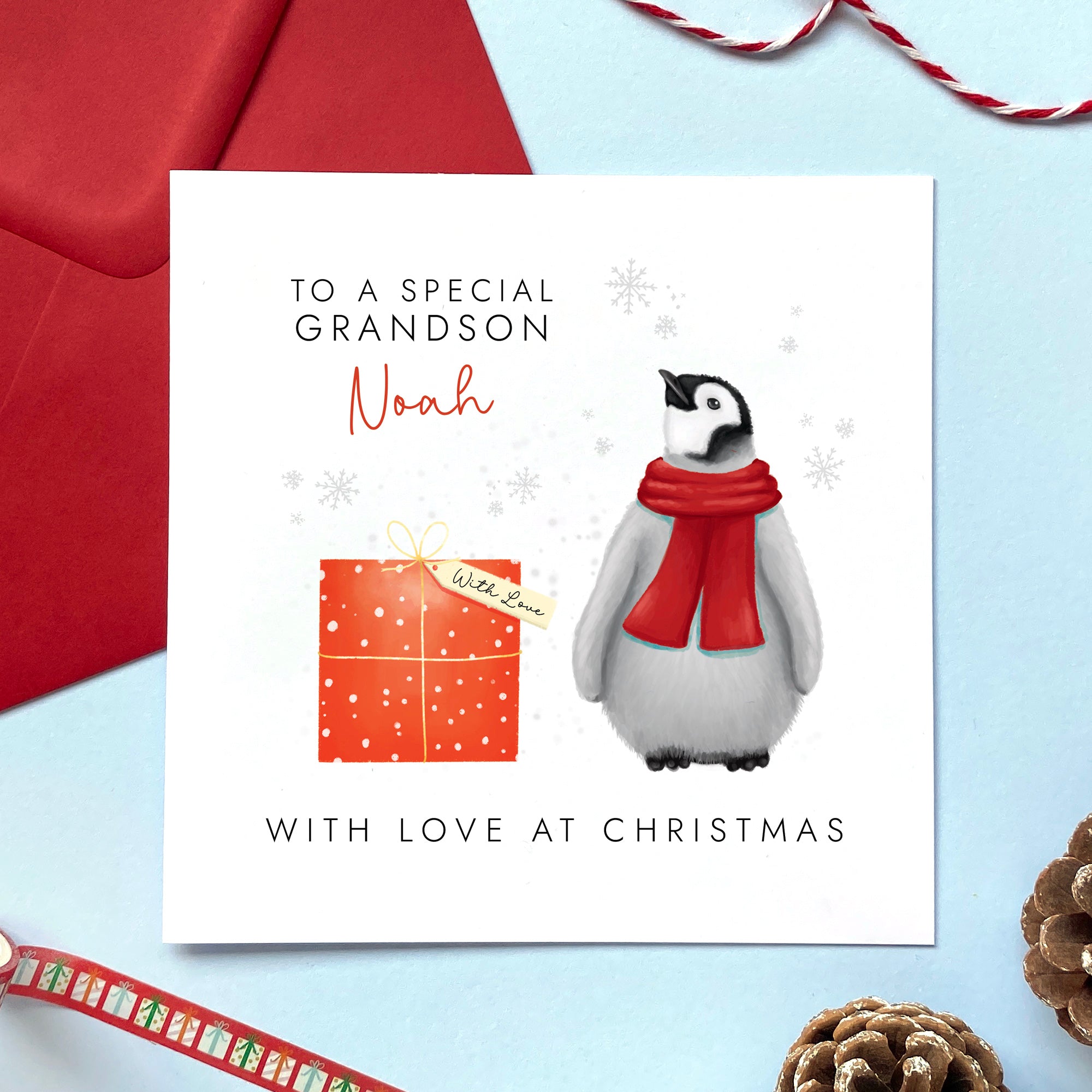 A personalised Christmas card for children featuring a baby penguin in a red scarf. It can be personalised with any relation for both boy and girl, including Son, Grandson, Nephew, Daughter, Granddaughter and Niece. A name can be added.