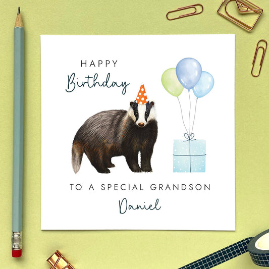 A personalised birthday card for him featuring a british badger. The card in the photo is for Grandson.