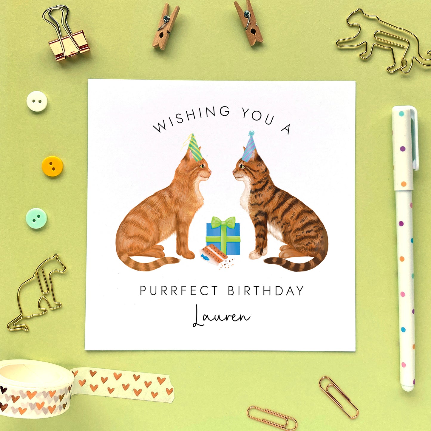 A personalised birthday card with two cats. Both cats can be chosen from a variety of different options. It's suitable for any relation, both him or her. The cats on the card in the photo are ginger and brown tabby.