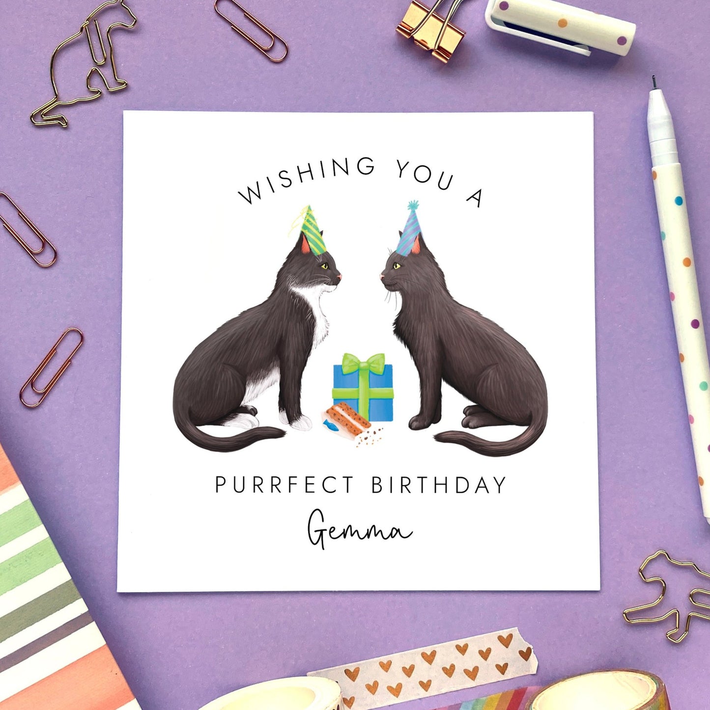 A personalised birthday card with two cats. Both cats can be chosen from a variety of different options. It's suitable for any relation, both him or her. The cats on the card in the photo are tuxedo and black.