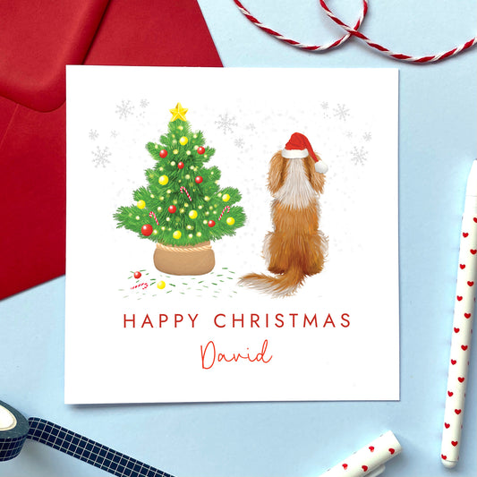 A personalised dog Christmas card featuring a white and brown blenheim king charles spaniel.