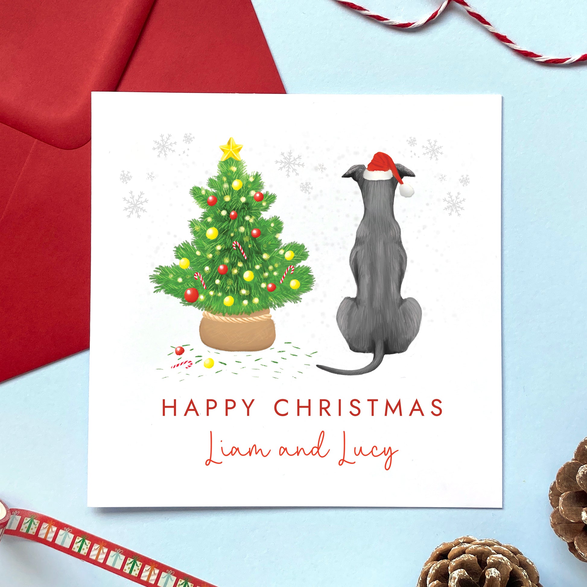 A personalised dog Christmas card featuring a grey blue whippet or greyhound.