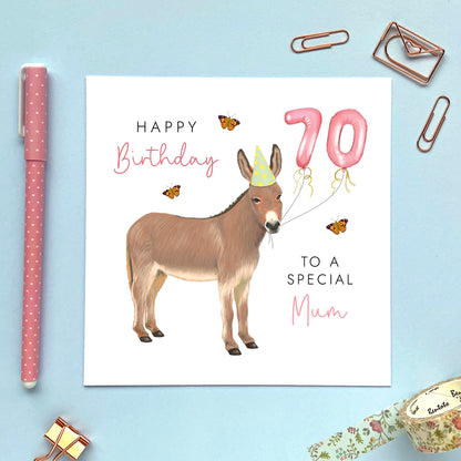 A personalised birthday card for her featuring a donkey with birthday balloons. It can be personalised with a name, relation and any age. The card in the photo is a 70th birthday card for Mum.