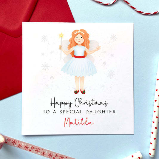 A personalised Christmas card for Daughter featuring a ginger haired festive themed fairy. It can be personalised with a name.