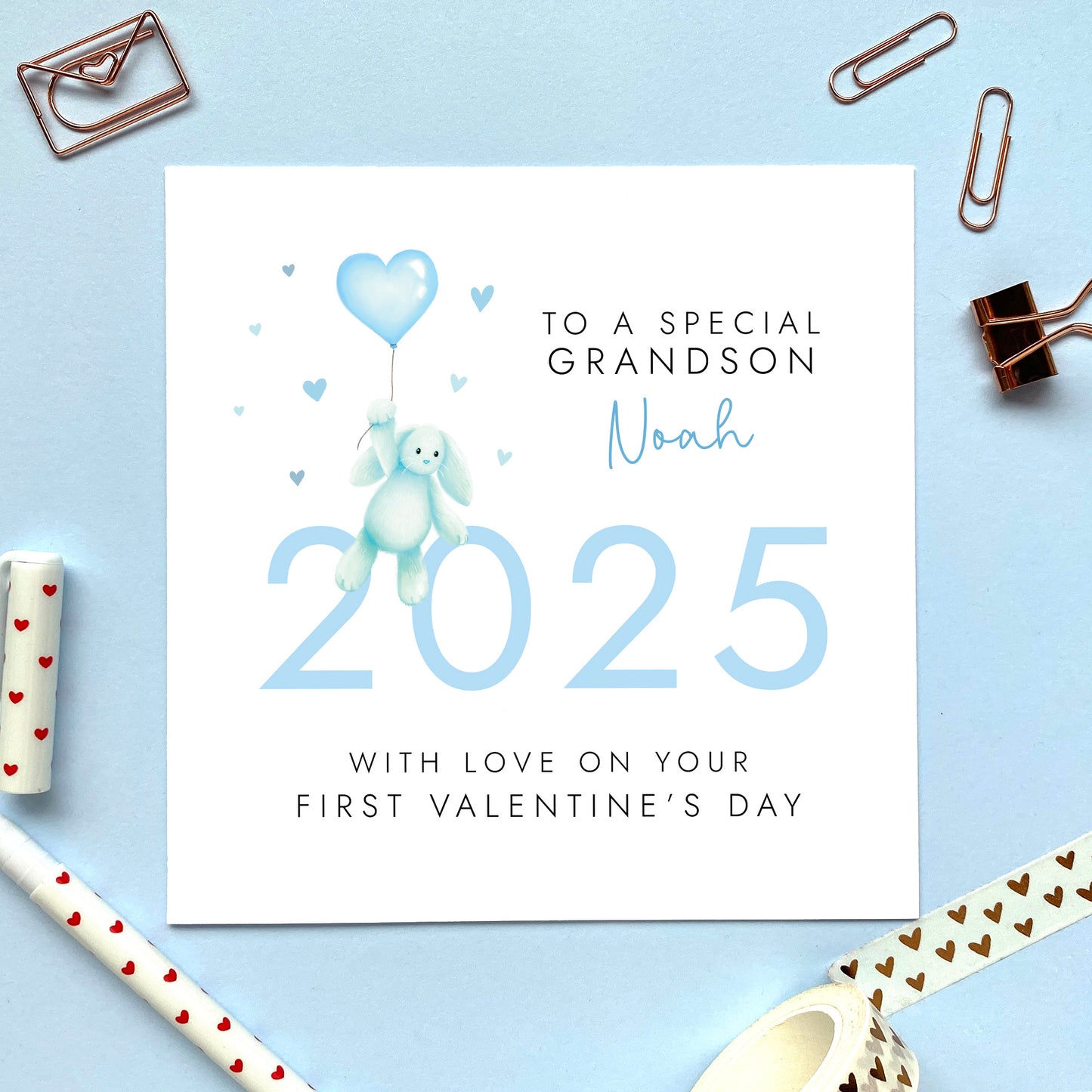 A personalised first valentine's day card for baby's 1st valentines. Including a pastel blue theme and a baby toy bunny, it can be personalised with any boy's name. The card in the photo is for Grandson, it can be changed to be made suitable for Son, Great Grandson, Godson and Nephew.