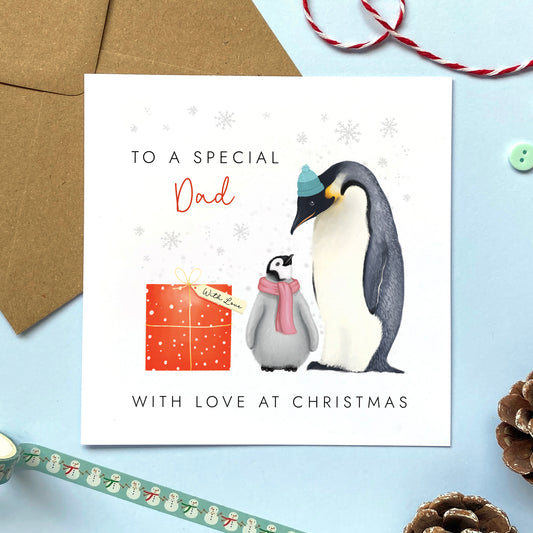 A personalsed penguins christmas card for Dad from one child or baby.