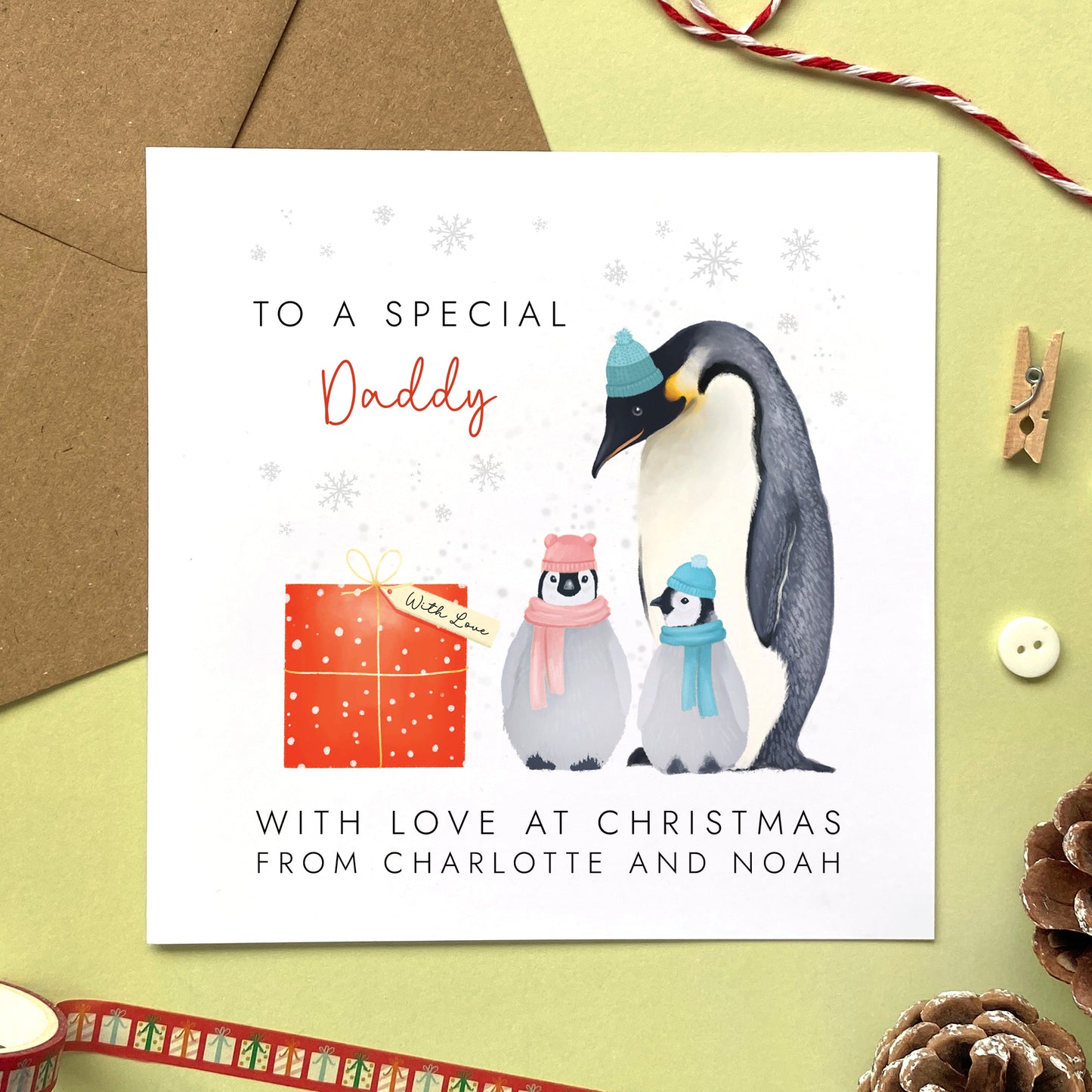 A personalised penguins Christmas Card for Daddy from two children.