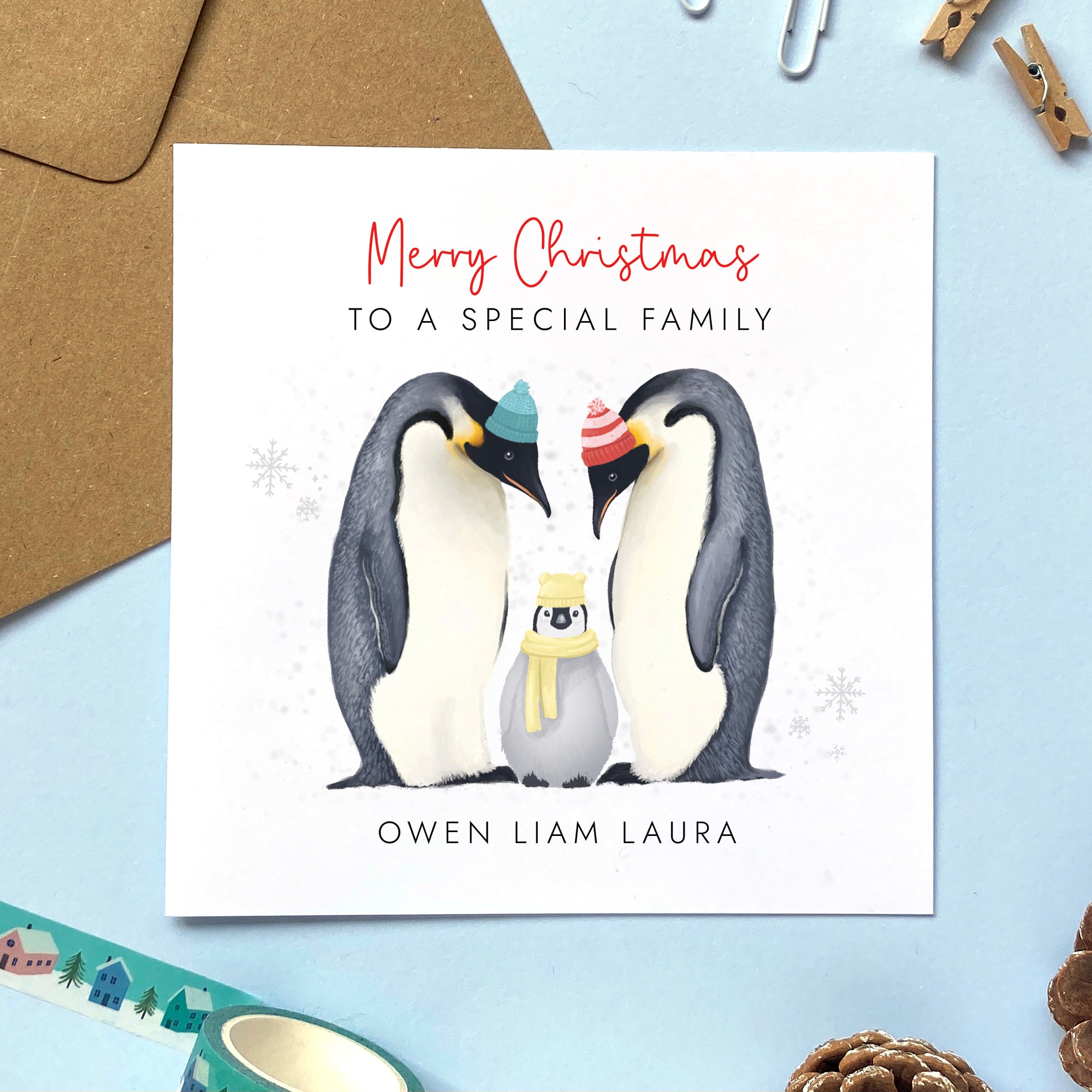 A personalised penguins Christmas Card for family with one baby or child.