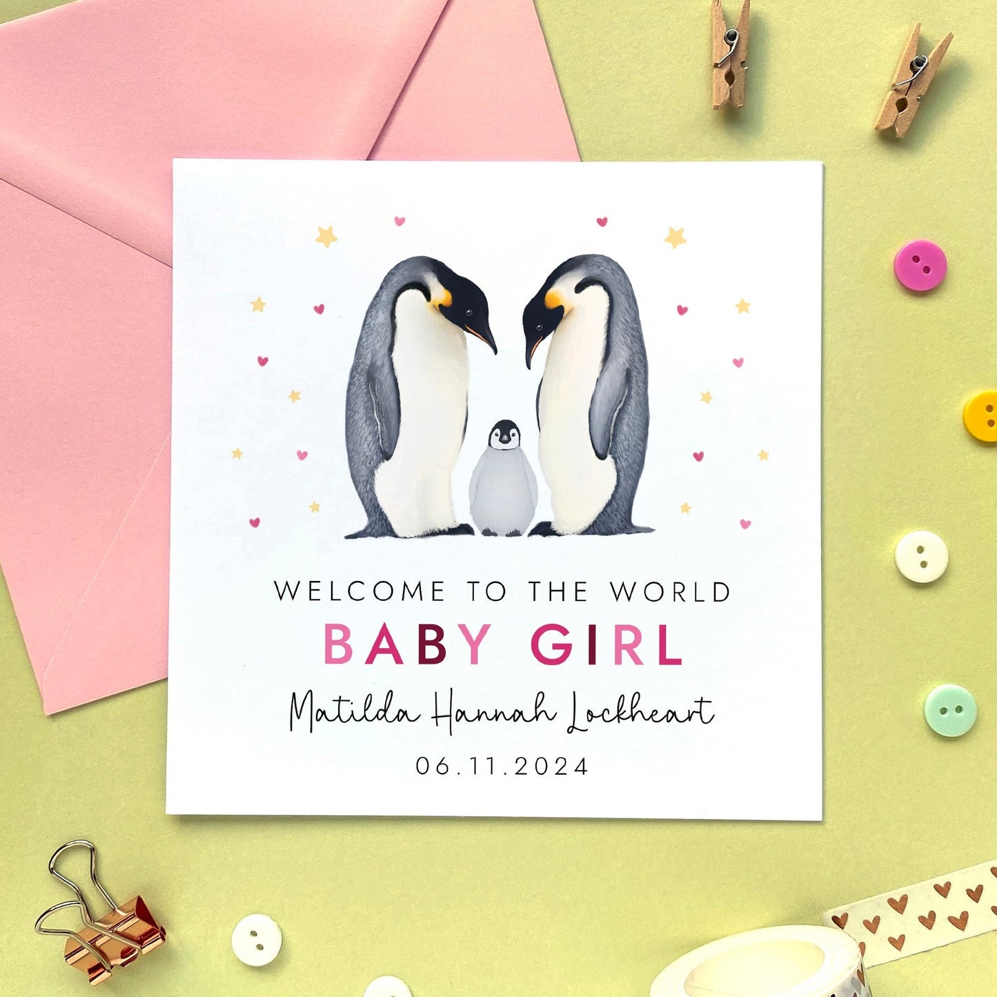 A personalised penguins new baby card for girl.