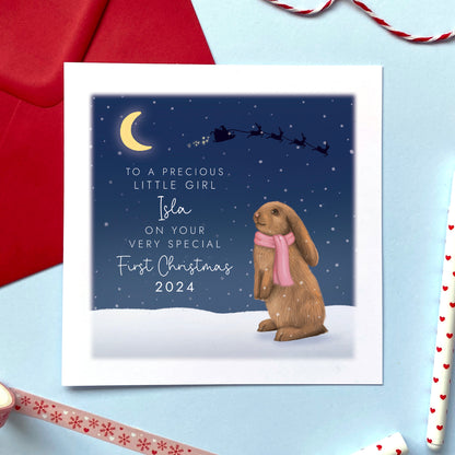 A personalised bunny rabbit First Christmas Card for a baby girl. The card in the photo is a 1st Christmas Card for Little Girl.