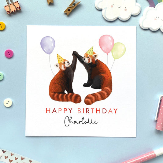 A personalised birthday card for her featuring a pair of red pandas with balloons. It can be personalised with a name and is suitable for both adults and children. Ideal for daughter, granddaughter, niece, sister and goddaughter.