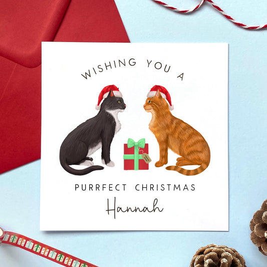 A personalised Christmas card where you can choose the two cats from a range of designs. Some of the cat designs include brown tabby, ragdoll, ginger, grey, white and black, both longhaired and shorthaired cats are available to choose. This card can be personalised with a name and is suitable for both him and her.